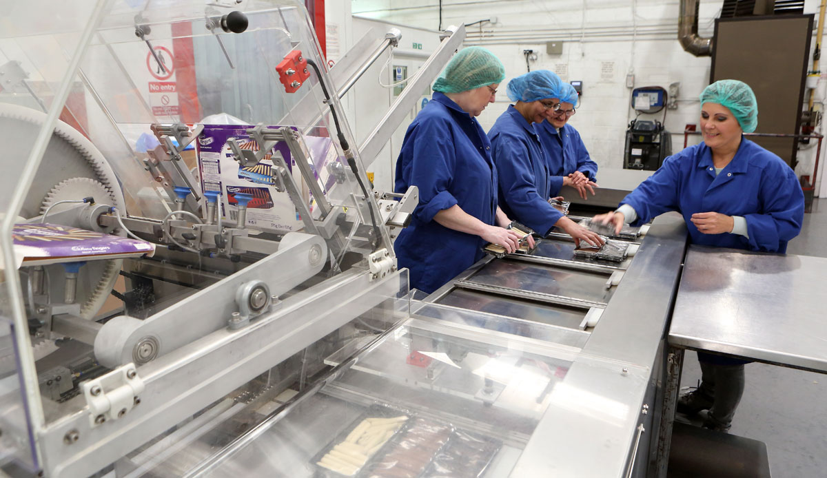 Photo: An automated cartoning machine filling boxes of chocolate truffles