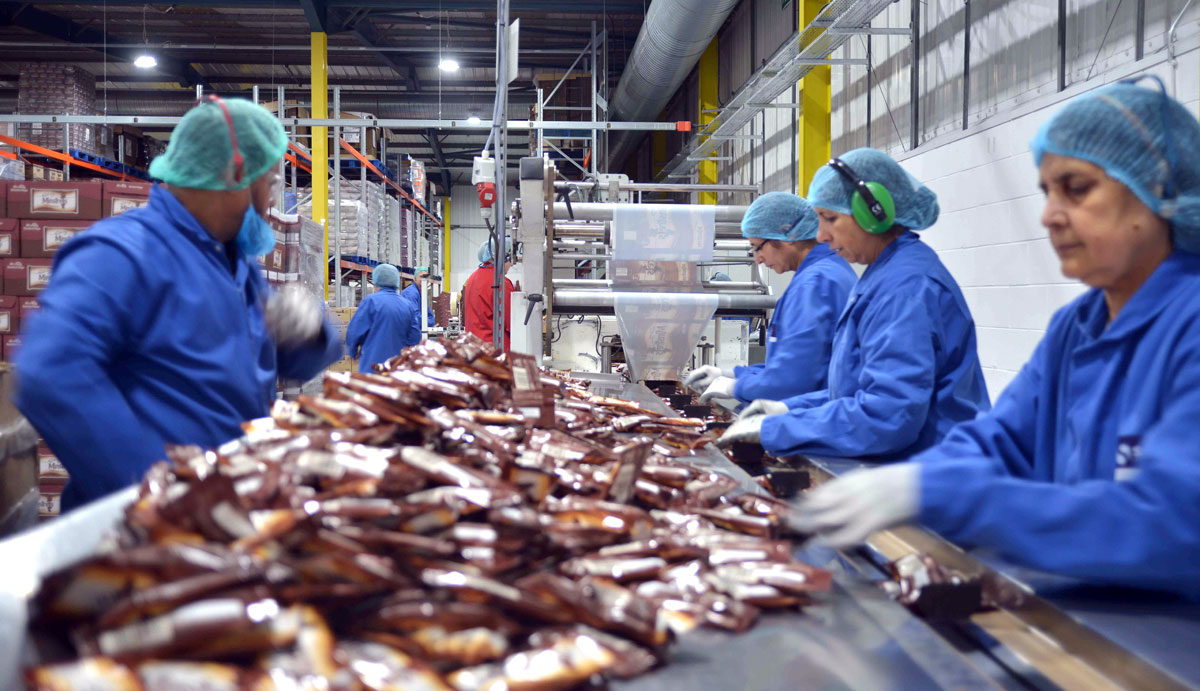 Photo: Workers inspecting confectionery after flow-wrapping at SGL Co-packing factory